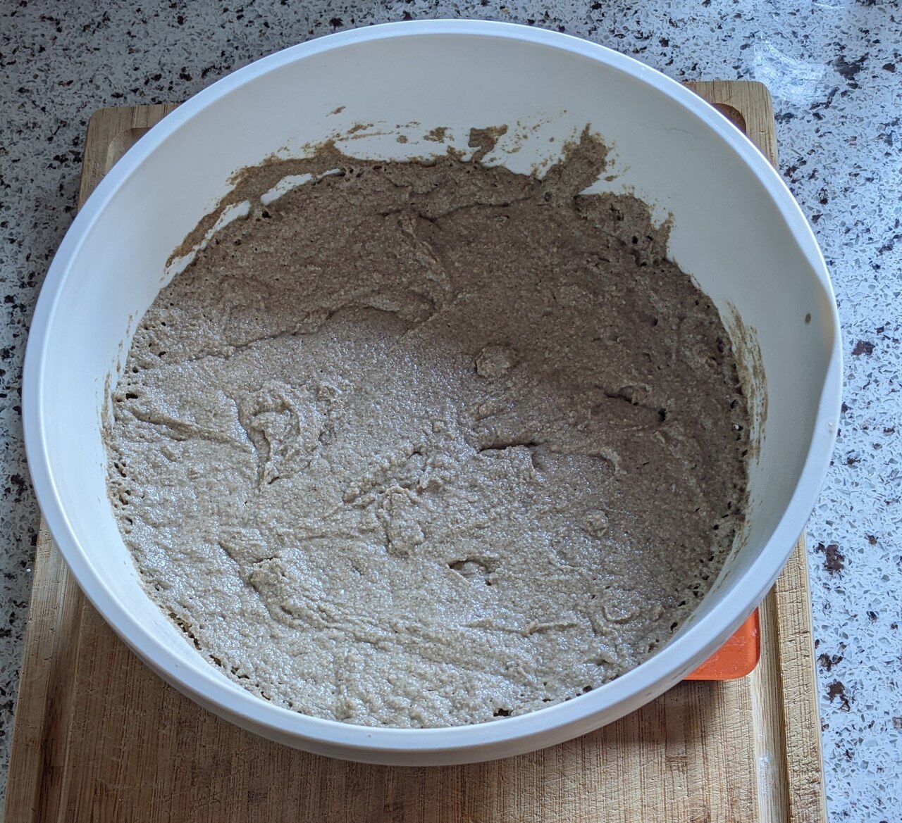 The pre dough has risen. Ideally the middle is slightly elevated and has not yet fallen in (the dough in this picture was not given enough time)